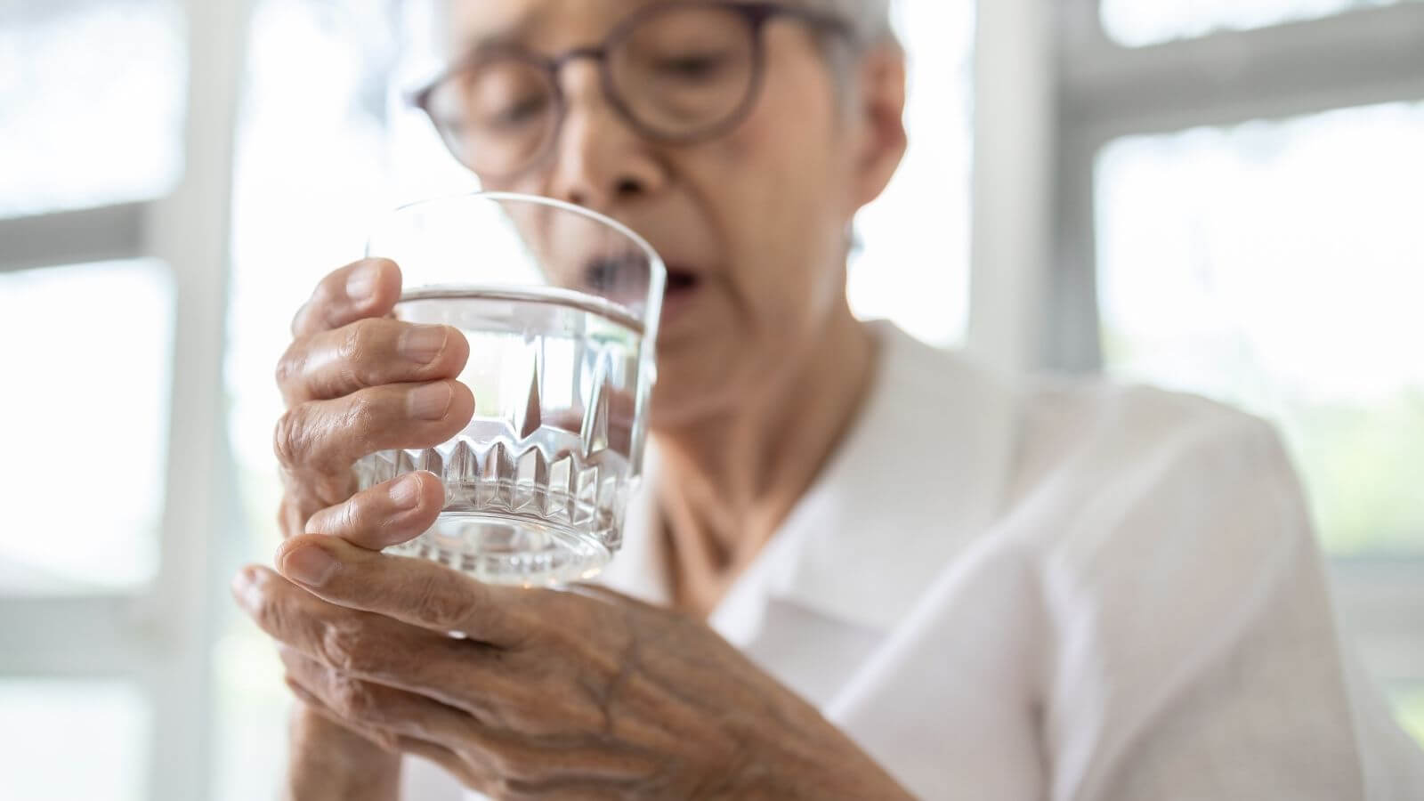 Parkinson's patient lifts a glass of water